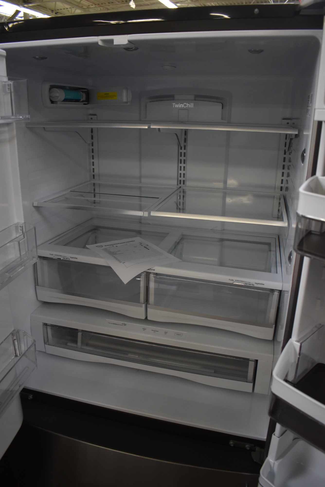 .New GE Fridge and the shelves slope dramatically. Nothing in the